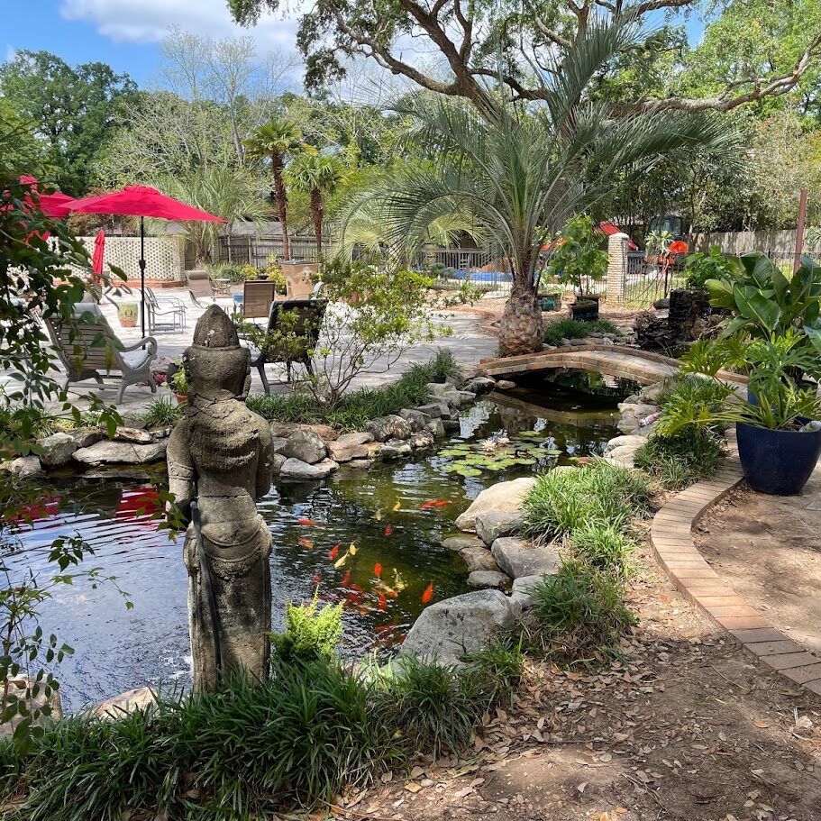 Backyard koi pond with statue and bridge